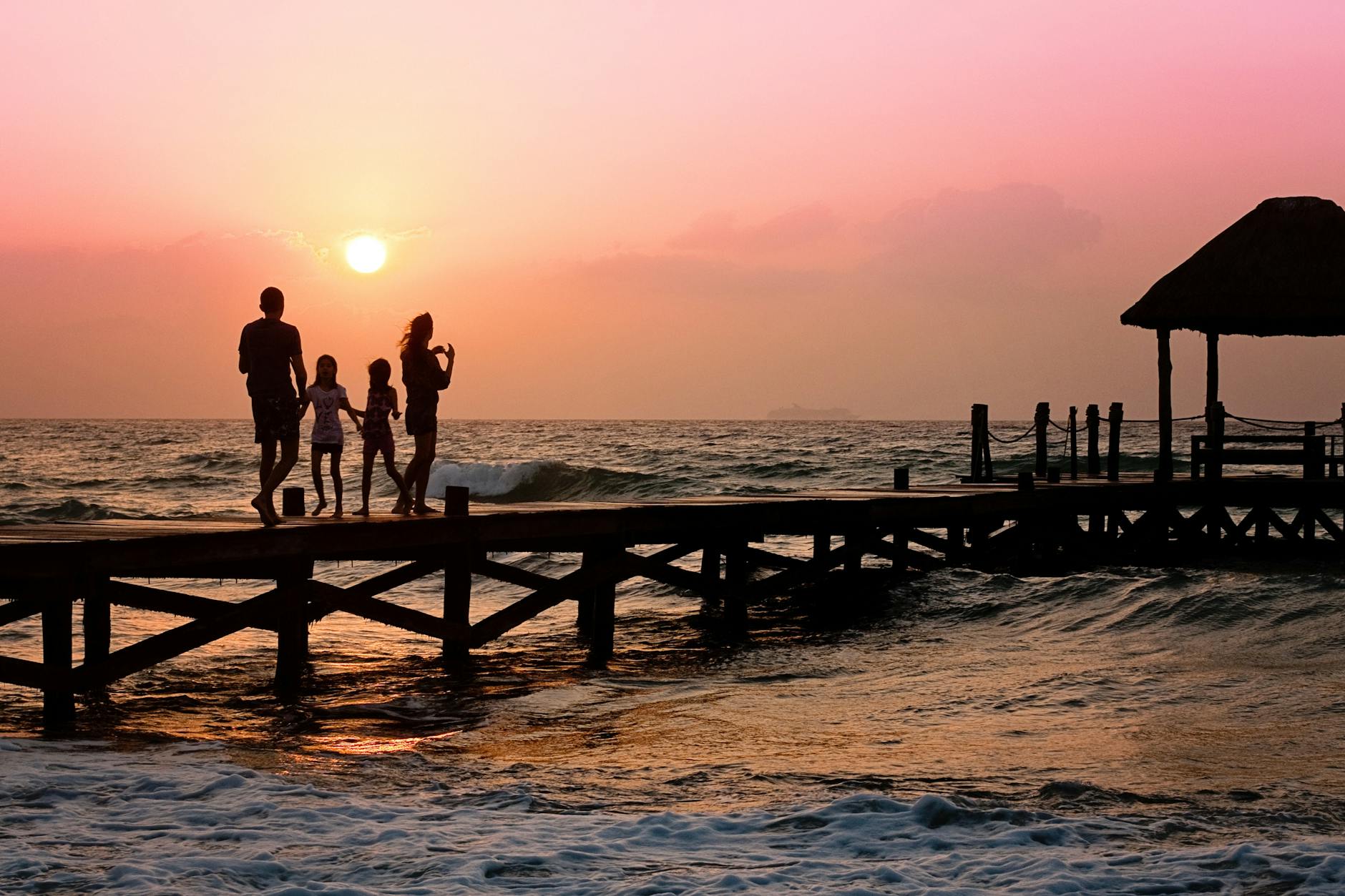 people standing on dock during sunset/families