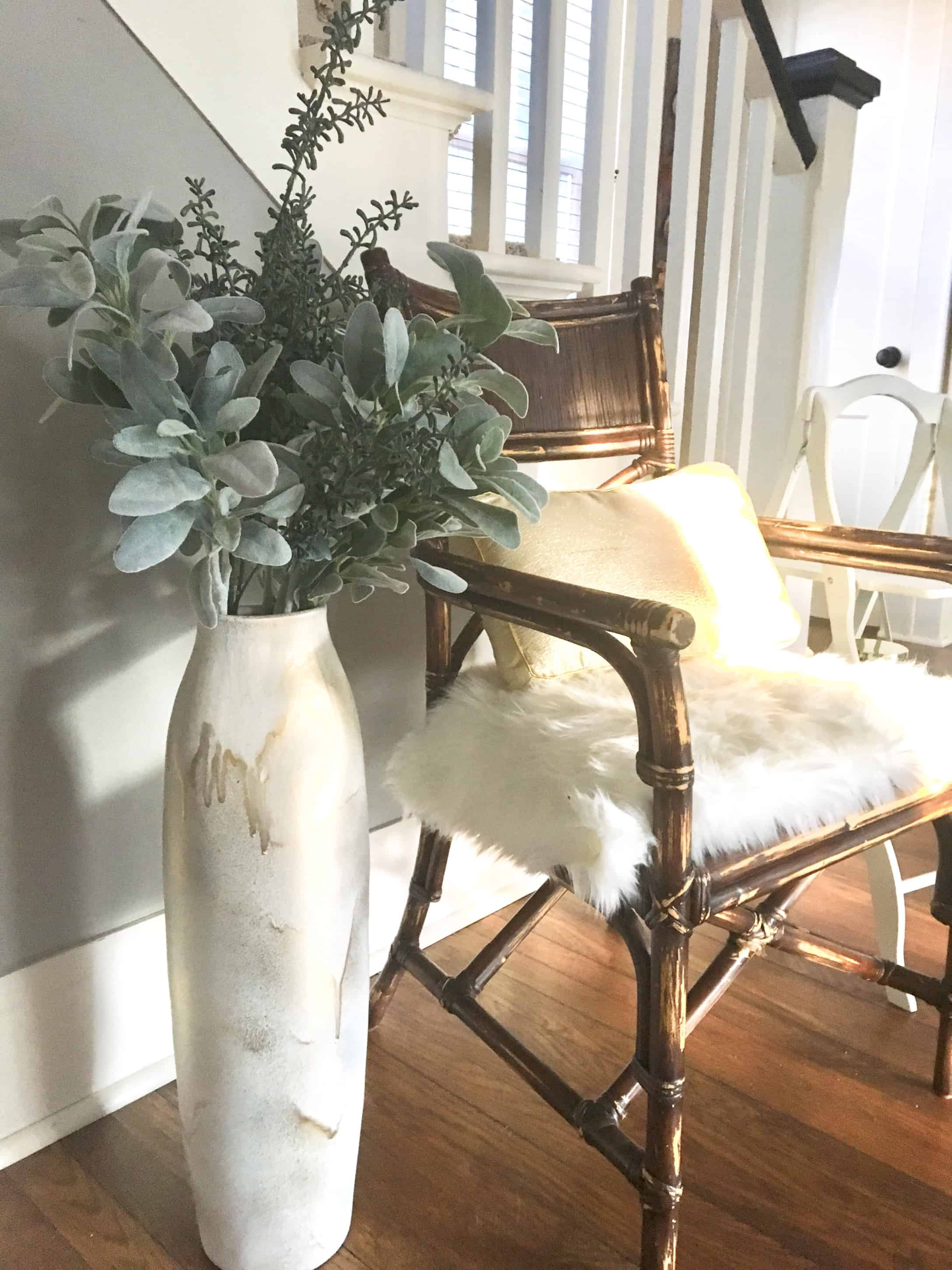 large white vase, about three feet high, painted white the painted over in spots with gold.