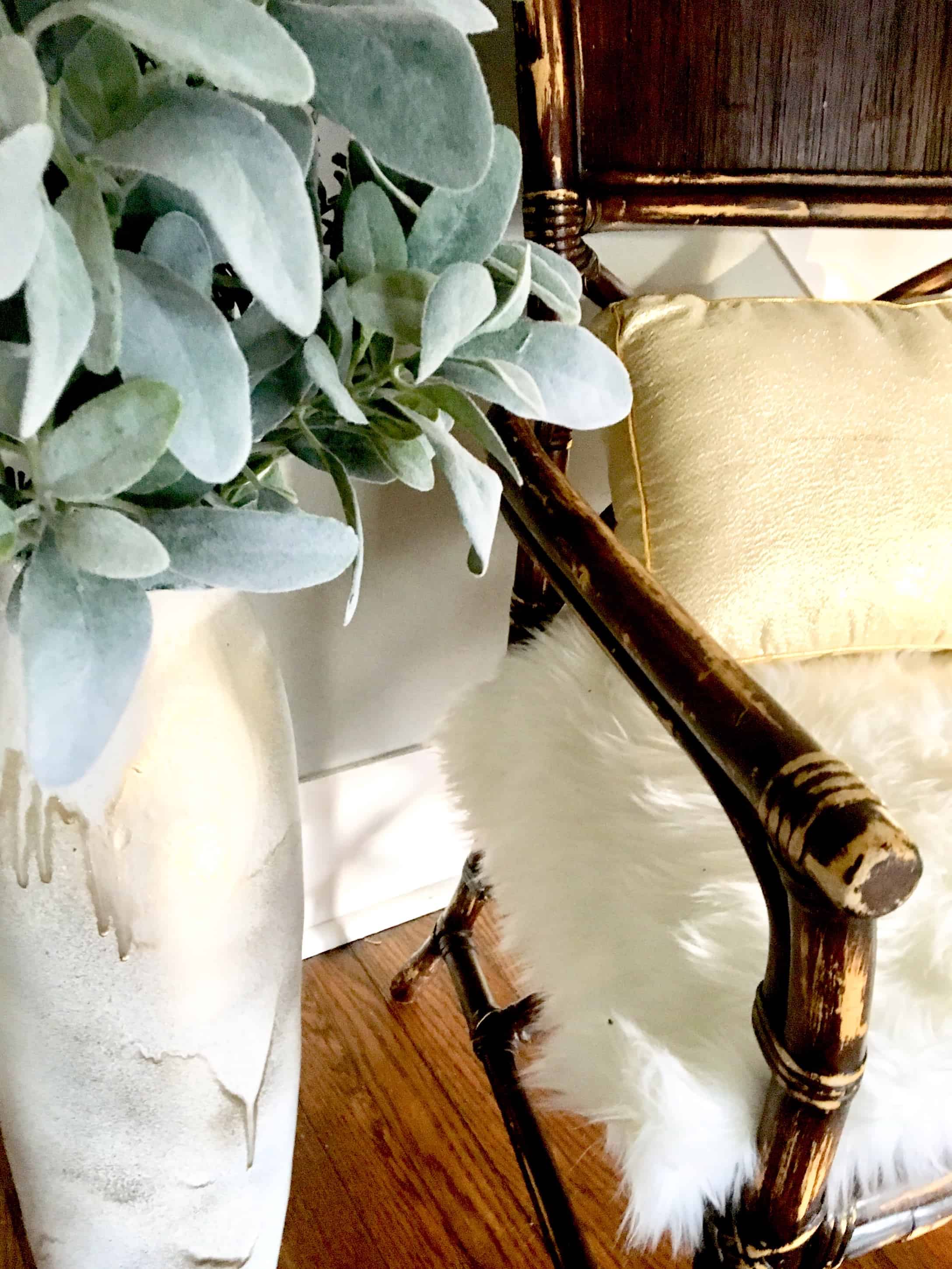 large white vase, about three feet high, painted white the painted over in spots with gold.