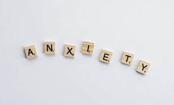 the words anxiety spelled out in scrabble tiles