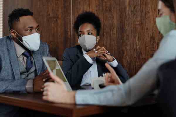 business people wearing face masks and talking
