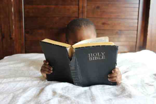 photo of child reading holy bible/being honest in prayer
