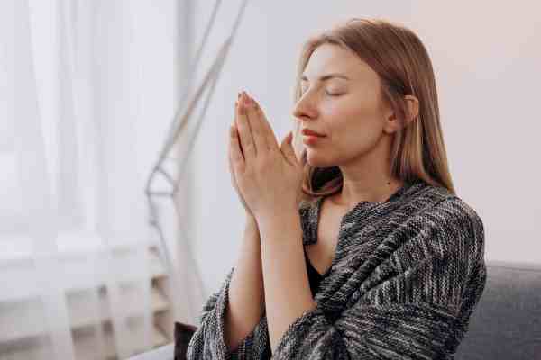 woman meditating in close up view/feeling intimidated in prayer