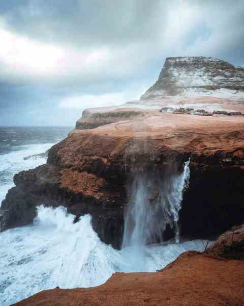 stormy sea with rocky cliffs in daylight/trusting God intentionally
