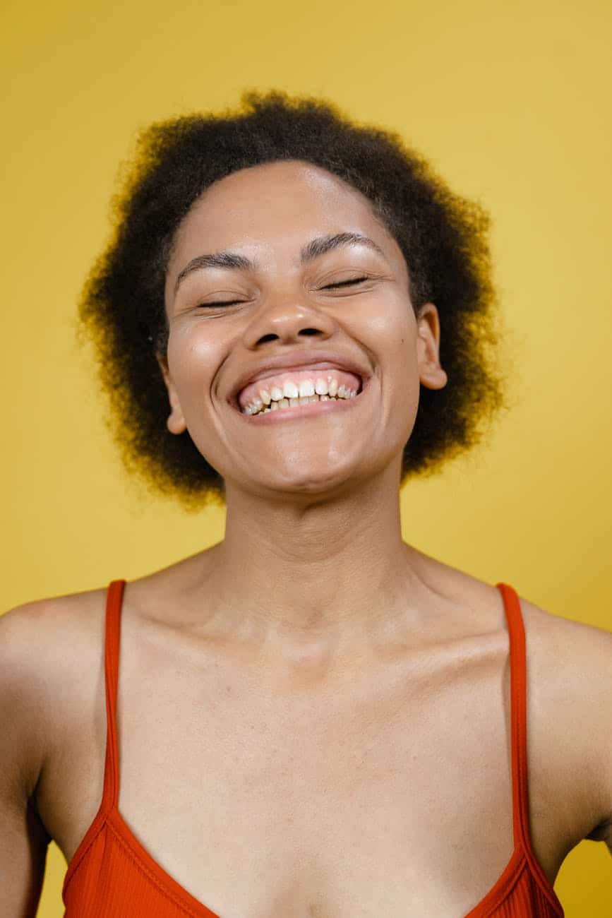 a smiling woman in red tank top