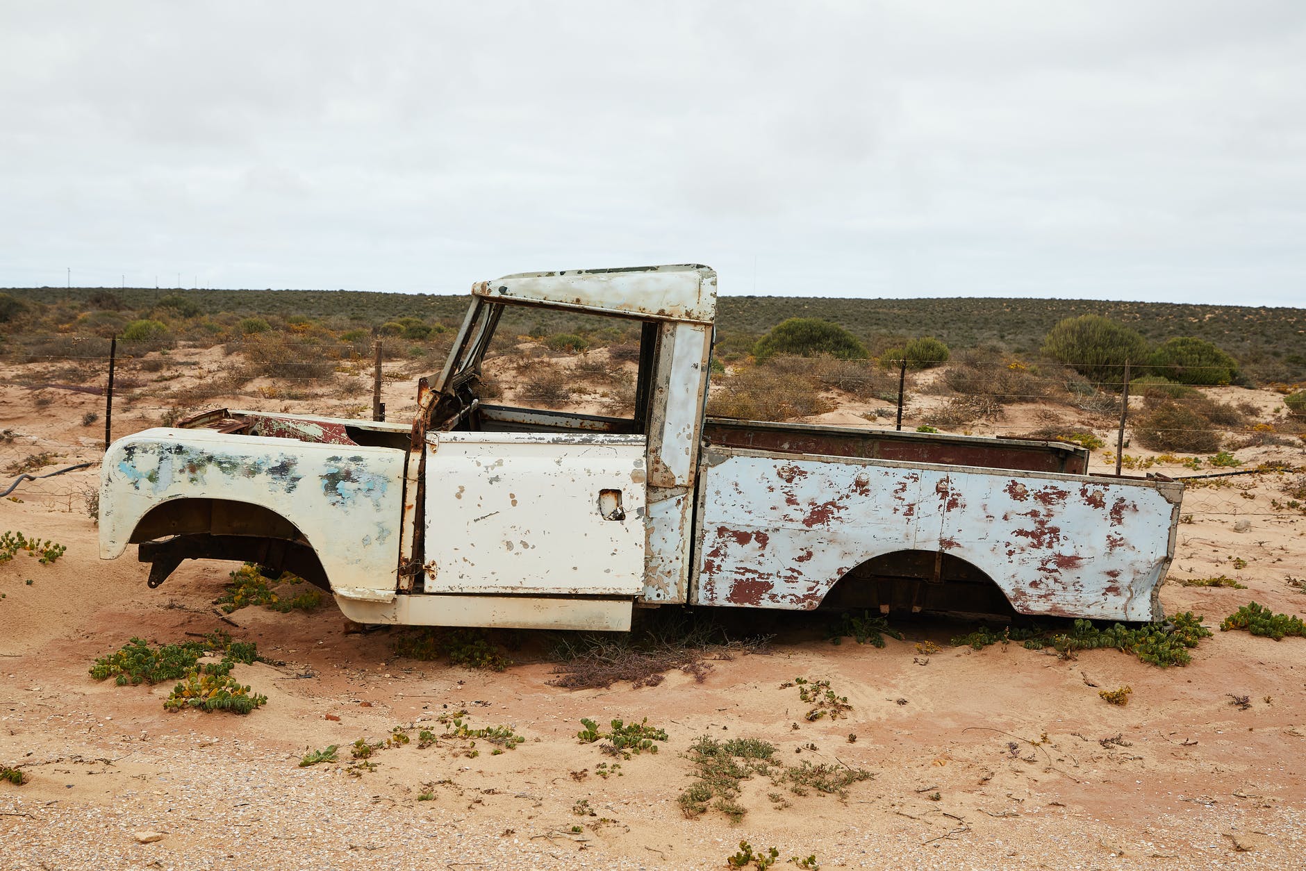 rusty abandoned car near fence in desert/Good endings to the terrible, no good days