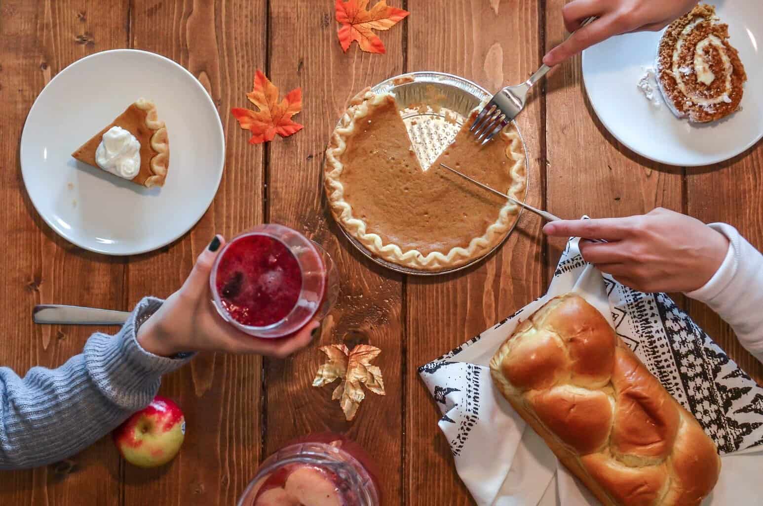 slicing of pumpkin pie placed on wooden surface/guarding our hearts at Thanksgiving