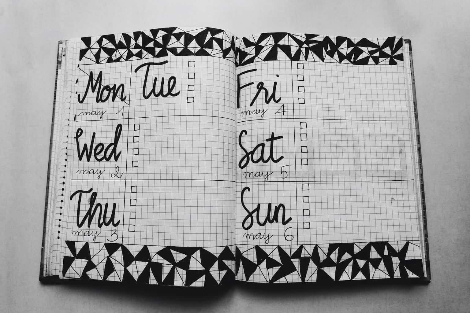 white and black weekly planner on gray surface/word choice matters