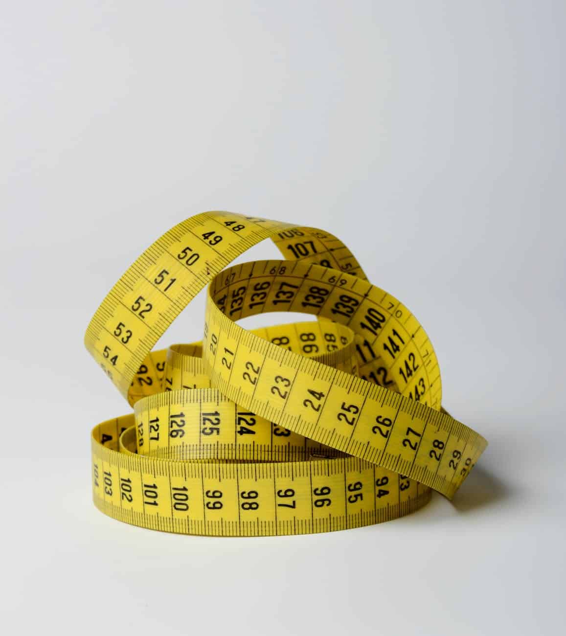close up photo of yellow tape measure/realistic and attainable goals