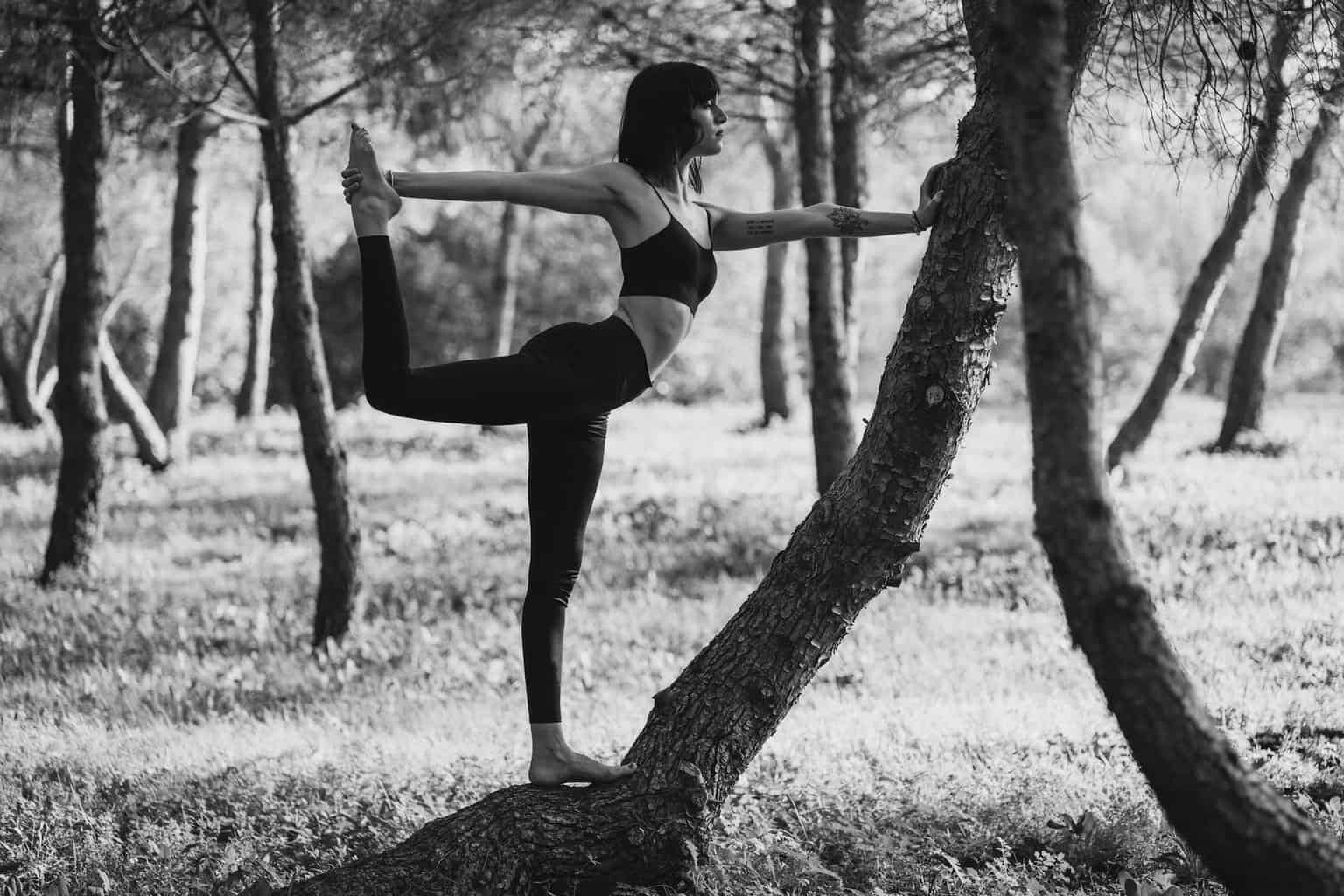 monochrome concentrated lady doing lord of the dance pose in park//realistic and attainable goals