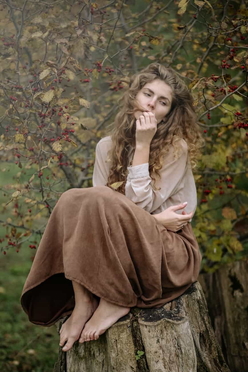 photo of woman sitting on wood