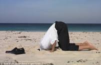 person sticking their head in the sand/raising God but not ignoring evil
