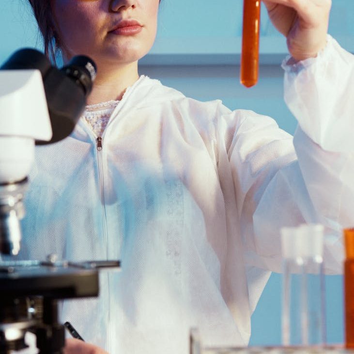 a woman holding while looking at a test tube/decisions