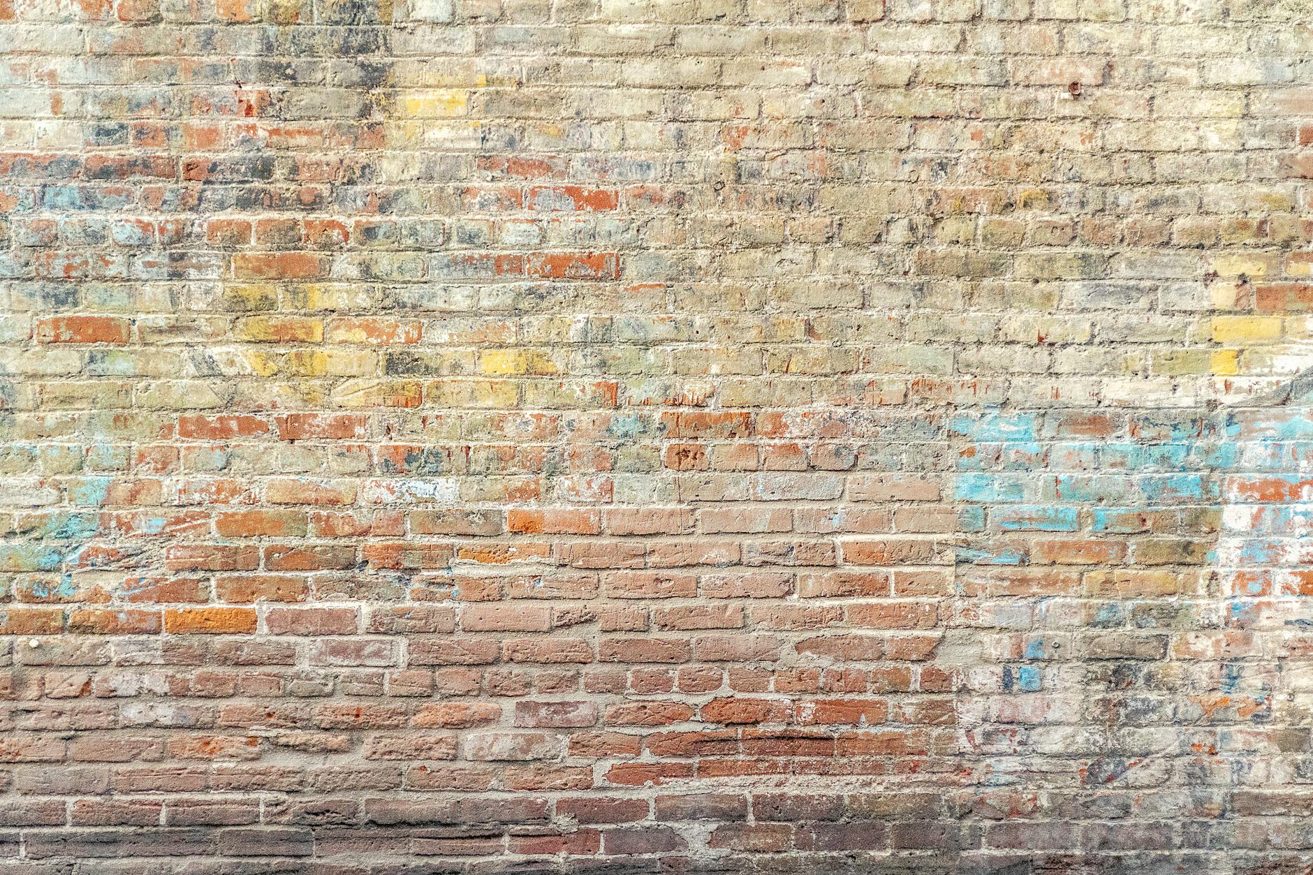 closeup photo of brown brick wall/words