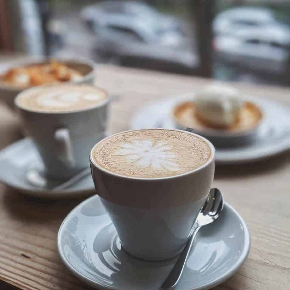 selective focus photography of coffee with latte art/depression
