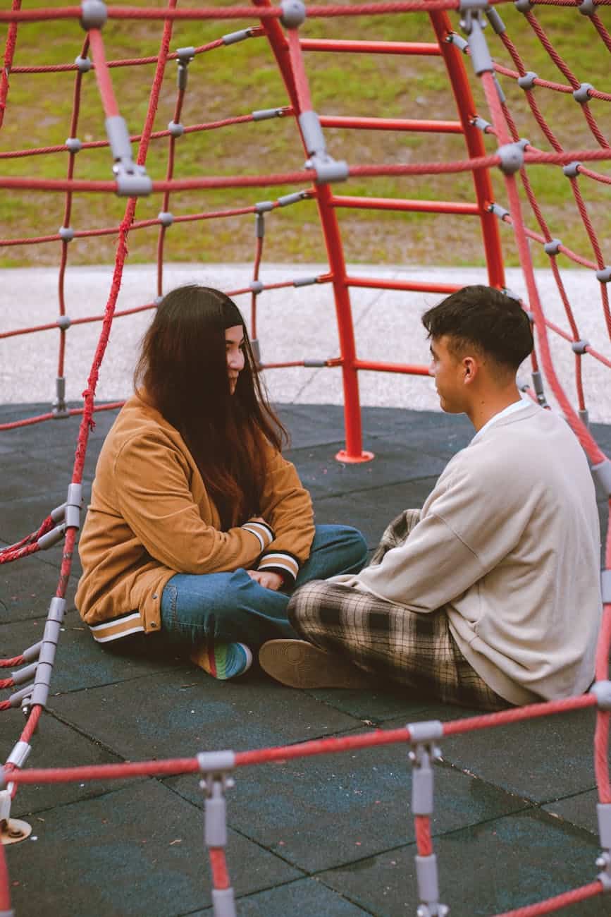 young couple sitting in playground structure/confronting honestly and with integrity