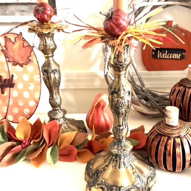img_5914 | goodthoughtsgoodlives Autumn mantel display with red pumpkins in metal vases, dried leaves, and a black 'Welcome' sign on an orange pumpkin.